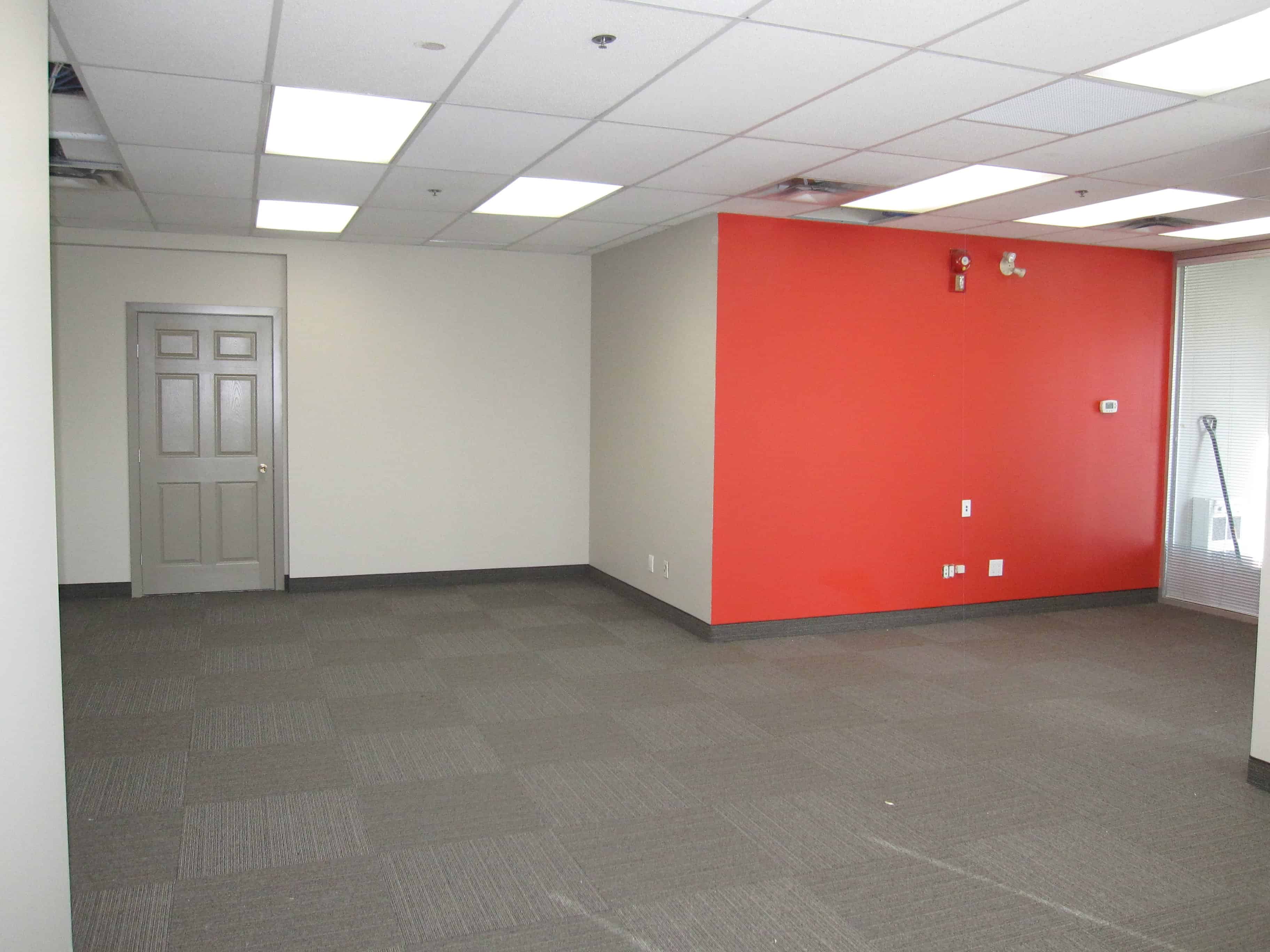 After drywall repairs, primed and painted with custom company color in Calgary office reception area walls, smooth and finished