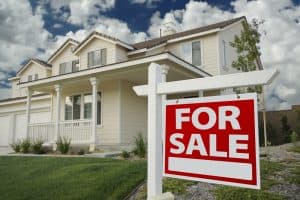 For Sale Real Estate Sign in Front of New House.